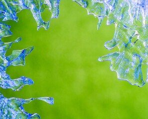 frozen water drops on a green background.blue ice patterns of unusual natural shape.beautiful...
