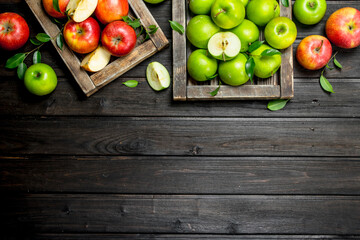 Red and green juicy apples in wooden boxes.