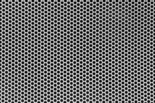 Metal grid background, speaker close-up. A steel grill with small holes full screen, ideal for dj and music events advertising.