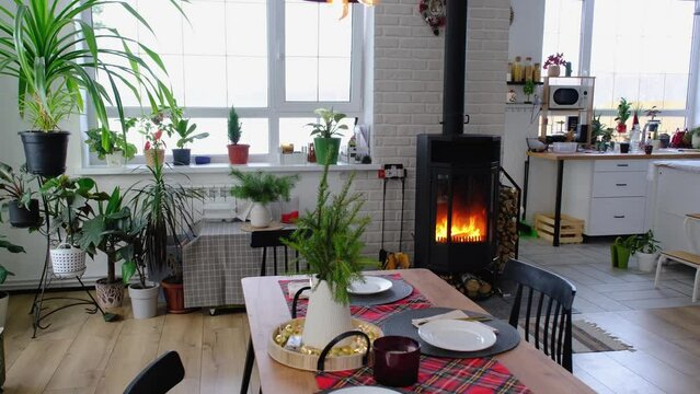 Black stove, fireplace in interior of house in loft style. Alternative eco-friendly heating, warm cozy room at home, burning wood