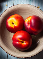 Ripe nectarines in a bowl on a wooden base. Healthy food.