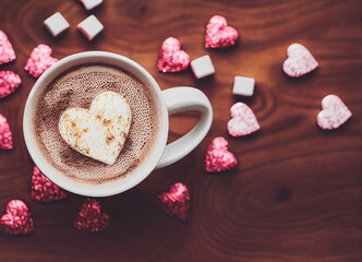 Obraz na płótnie Canvas Cappuccinos and chocolate candies top view coffee
