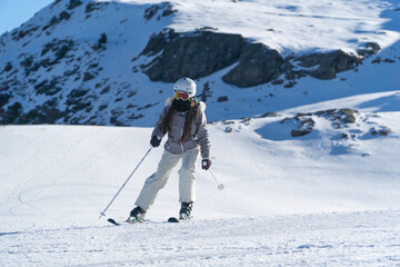 Girl skiing in the snow on the mountain on a sunny day