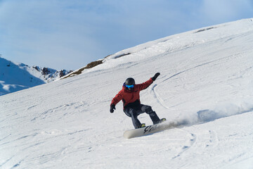 man snowboarding on the mountain on a sunny day