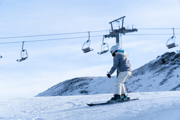 Fototapeta na wymiar Girl skiing in the snow on the mountain on a sunny day