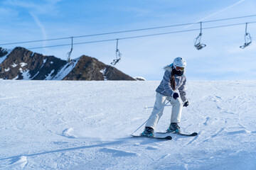 Girl skiing in the snow on the mountain on a sunny day
