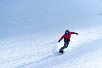 Fototapeta na wymiar man snowboarding on the mountain on a sunny day