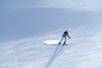 Girl skiing in the snow on the mountain on a sunny day