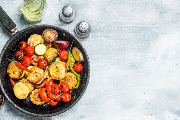 Grilled vegetables in a pan with spices.
