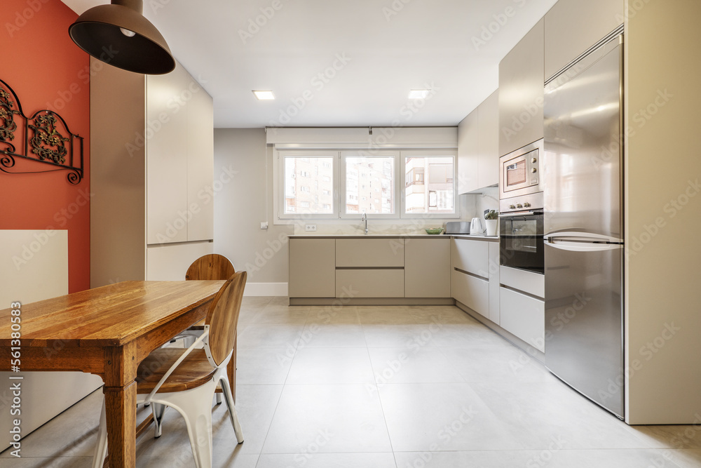 Wall mural office area of a kitchen in an apartment with gray tones in the furniture and a square wooden table 