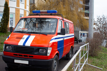 Red Rescue Vehicle. Rescue team parks its truck for fire safety inspection of the building.