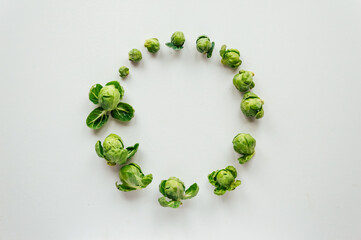 Brussels sprouts laid out in a circle on a white background place for text. High quality photo
