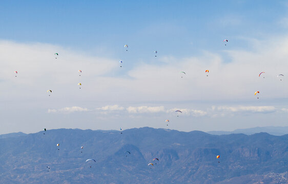 Paragliders over mountains in Taxco, Guerrero, Mexico.