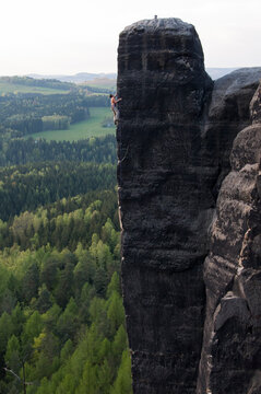 A man nears the summit of a tower.