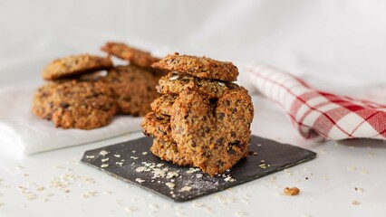 Homemade oatmeal and chocolate cookies in the shape of a heart on a wh
