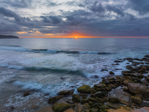 Soft sunrise seascape with clouds and colour on the horizon