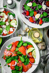 Various salads of organic vegetables, fish and cheese with olive oil and spices .