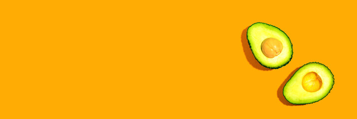 Fresh avocado halves overhead view - flat lay