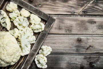 Fresh cabbage in a wooden tray.