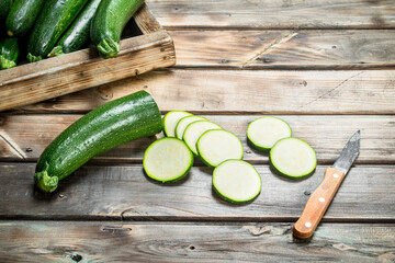 Sliced zucchini with a knife.