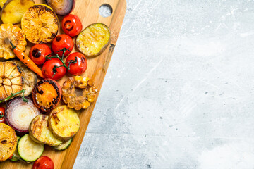 Grilled vegetables with spices and herbs on a cutting Board.