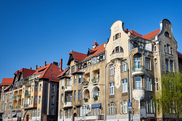 a historic tenement house with a relief in the city of Poznan