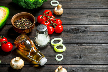 Organic food. Different raw vegetables with mushrooms and olive oil.