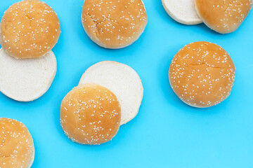 Hamburger buns with sesame on blue background.