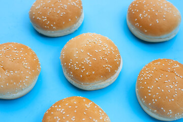 Hamburger buns with sesame on blue background.
