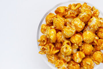 Honey caramel popcorn on white background.