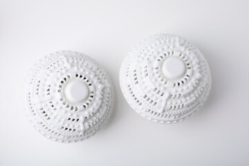 Dryer balls for washing machine on white table, flat lay