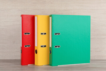 Bright hardcover office folders on white wooden table