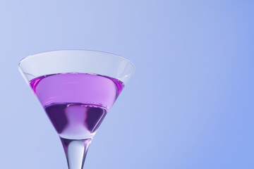 Fresh cocktail in martini glass on light blue background, closeup. Space for text
