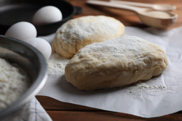 Fototapeta na wymiar Raw dough, eggs and flour on wooden table. Cooking ciabatta