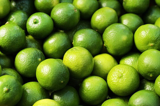Fresh ripe green limes as background, closeup