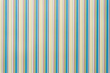 scrapbook paper with mostly yellow and blue green vertical stripes
