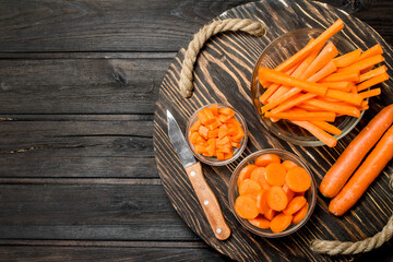 Fresh carrots on a cutting Board with a knife.