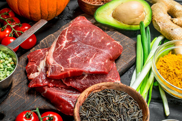 Healthy food. Organic food assortment with raw beef steaks .