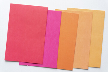 overlapping red, pink, orange, and orange yellow blank cards with space for your text