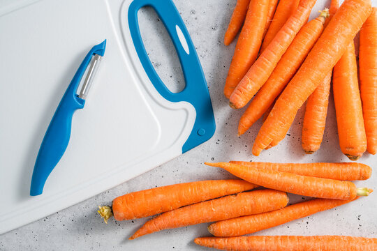 Carrots Close-up. Fresh Raw Organic Carrot On A Light Grey Stone Background, Flat Lay