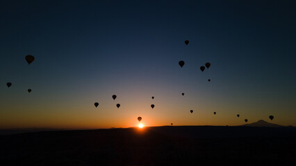 Hot air balloon flying over rock landscape at Cappadocia Turkey