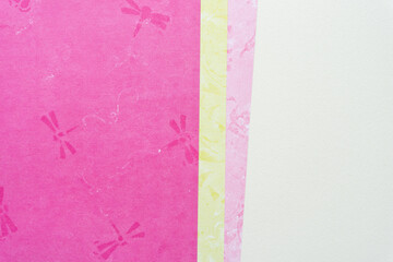 mostly pink scrapbook paper with dragonfly pattern and stripes of light yellow and pink paper