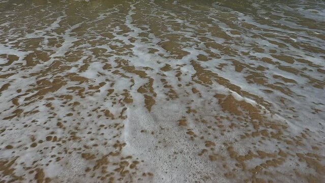 water flowing into the sand