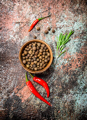 Pepper in bowl with red pepper in the pod.