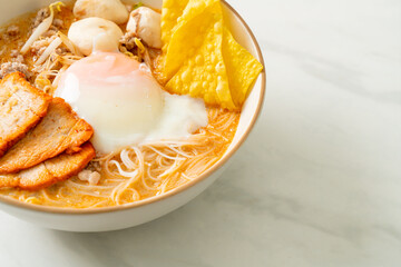 Rice vermicelli noodles with meatball, roasted pork and egg in spicy soup