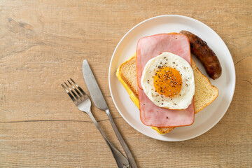 bread toasted cheese topped ham and fried egg with pork sausage