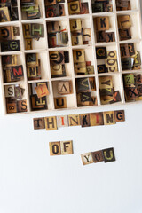 thinking of you and wooden box with chipboard tiles displaying vintage style letters