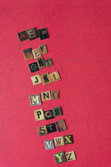 letters of the alphabet composed from chipboard tiles displaying vintage style letters