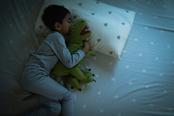 Top View of Asian boy having sweet dreams while Sleeping Cozily Bed