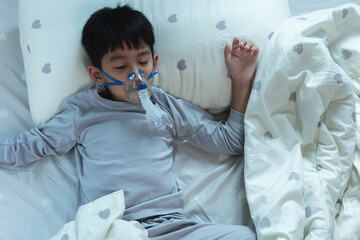 Sick Asian Boy Respiratory syncytial virus wears pediatric ventilator